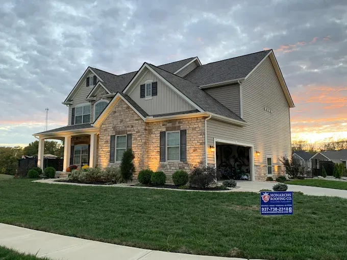A completed Monarchs Roofing Co. exterior renovation at dusk
