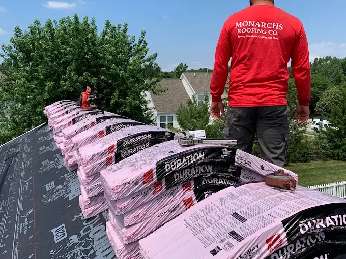 A Monarchs Roofing Co. crew member with Owens Corning Duration shingles
